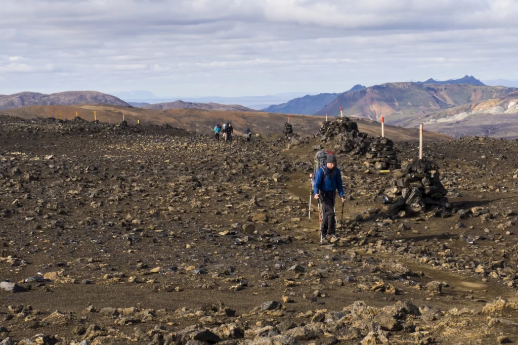 Wanderer auf Wanderweg in grauer Berglandschaft